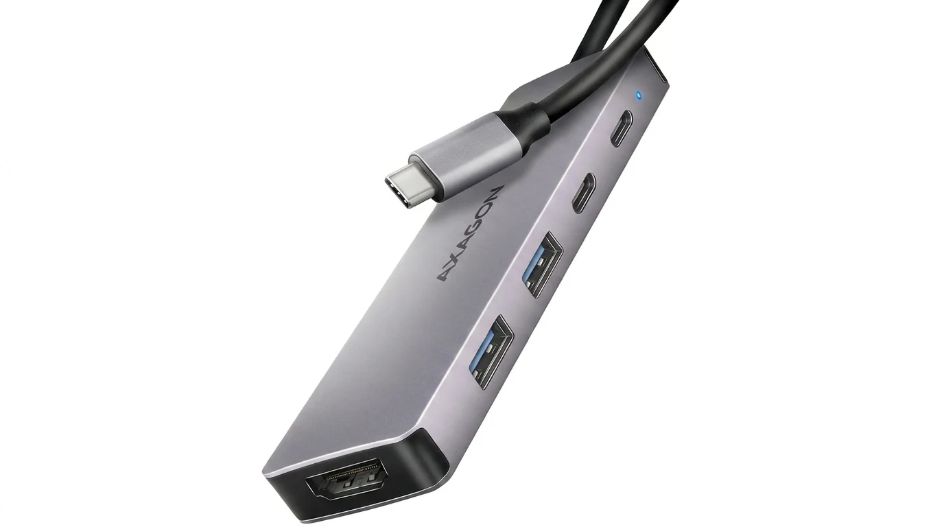 Sivý hliníkový USB hub AXAGON HMC-5H60 s integrovaným USB-C káblom, portami USB-A, USB-C a koncovým HDMI konektorom.