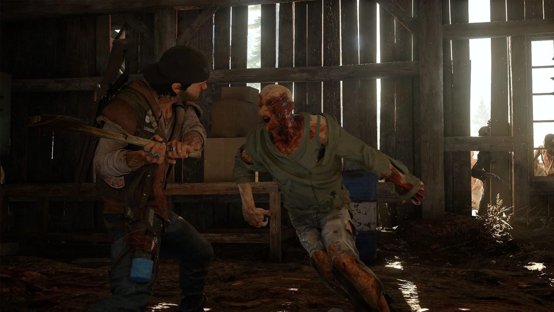Deacon St. John útočí zbraní na blízko na nakaženého freakera v dřevěné stodole ve hře Days Gone.